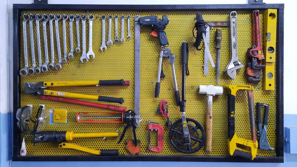 assorted hand tools on brown floor